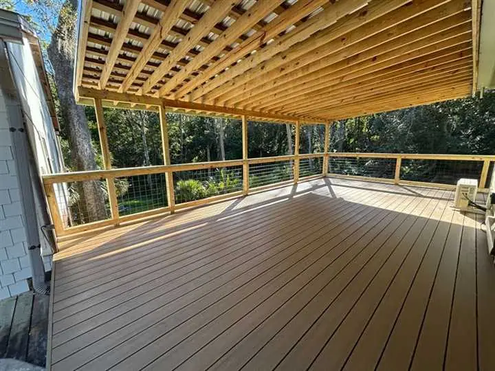 Open-rafter pergola over a waterfront paver patio