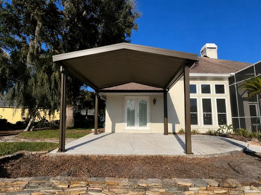 Aluminum pavilion with a gable roof over a backyard patio