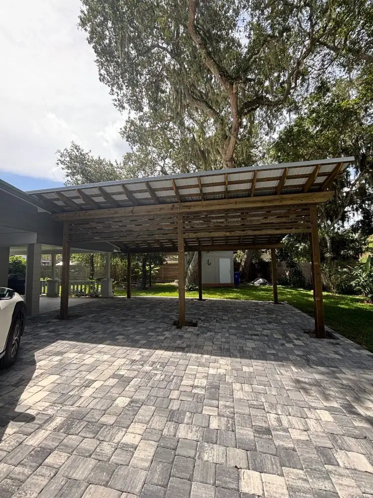 Covered cedar pergola carport over a paver driveway