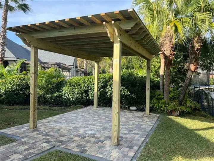 Pergola over a backyard paver patio