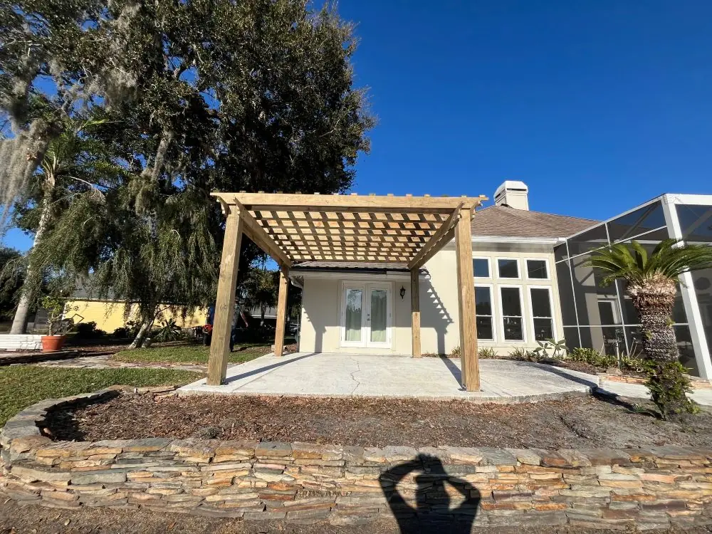 Attached cedar pergola over a backyard patio