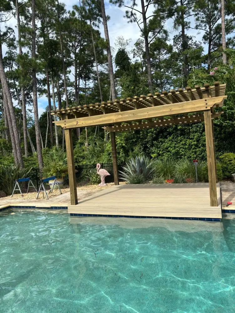 Poolside pergola over a backyard pool deck